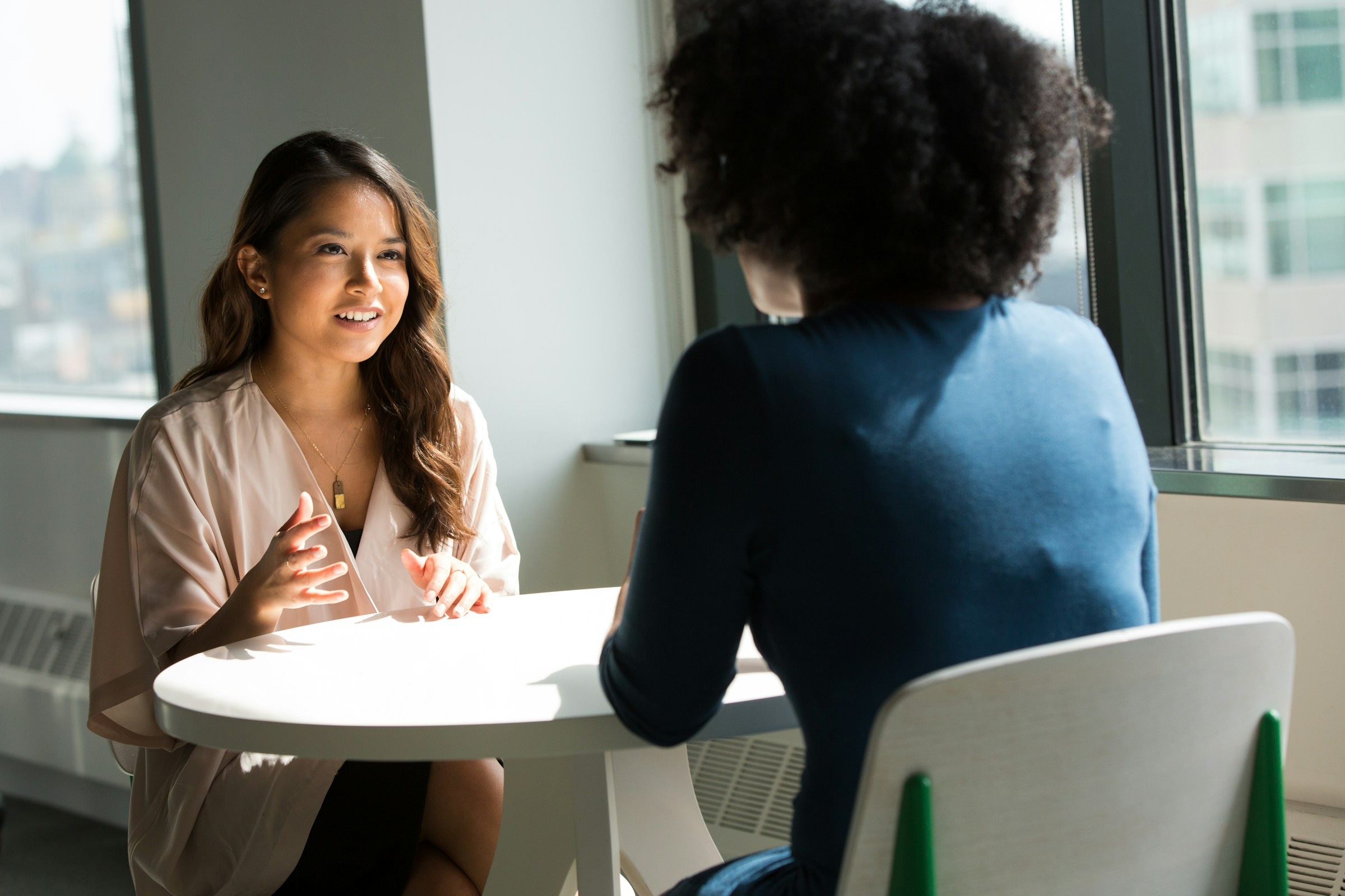 People discussing career opportunities in a bright workplace